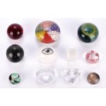 A collection of eleven assorted paperweights.