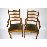 A pair of pine ladder back open armchairs.