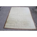 A cream carpet with acanthus leaf boarder.