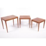 A mid-century teak nest of three tables.