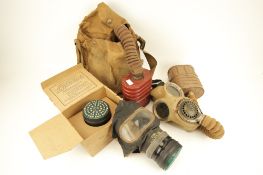 A collection of gas masks. Including a boxed respirator issued to Mrs J Haydon, etc.