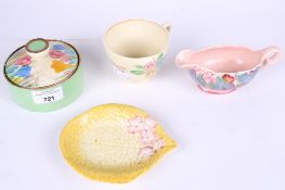 A collection of four assorted pieces of Clarice Cliff pottery.