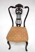 An Edwardian mahogany bedroom chair.