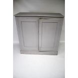 A vintage pine two-door cupboard, painted grey.