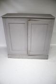 A vintage pine two-door cupboard, painted grey.