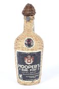 A vintage bottle of Hooper's Rare Port. In wicker case, no volume shown but weighing 1.39kg.