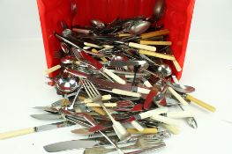 A box of assorted vintage cutlery. Including spoons, knives and forks, etc.