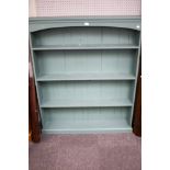 A free standing green painted bookcase. With three fixed shelves.