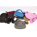 A collection of eight assorted Kipling womens' handbags.