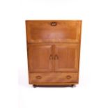 Vintage / Retro : A Blonde Ercol cabinet comprising of a fall front top over a two cupboard door