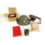 A group of assorted WWII collectables. Including a helmet, lamp, etc.