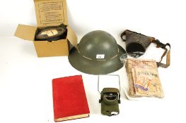 A group of assorted WWII collectables. Including a helmet, lamp, etc.