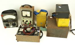 A collection of assorted vintage electrical testing meters.