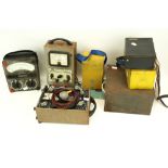 A collection of assorted vintage electrical testing meters.