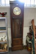 A 1930s oak long case clock.