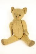 A vintage jointed teddy bear.