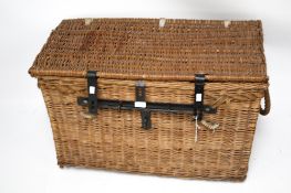 A large vintage wicker laundry basket with rope handles. Wrought iron bolt and clasp.