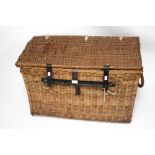 A large vintage wicker laundry basket with rope handles. Wrought iron bolt and clasp.