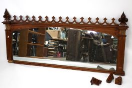 An oak framed overmantel mirror, rectangular with pierced details.