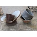 A vintage tin bath and assorted metal pales and pots.