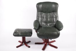 A green leather easy lounge armchair and matching foot stool.