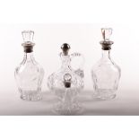 Four Victorian and later silver mounted glass decanters.