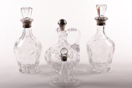 Four Victorian and later silver mounted glass decanters.