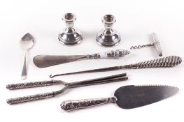 An assortment of Victorian and later silver. Comprising a pair of weighted candlesticks, H6.