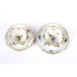 Two late 19th century Meissen flower encrusted teacups and saucers.