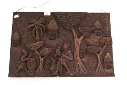 A contemporary carved wooden tribal plaque.