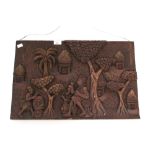 A contemporary carved wooden tribal plaque.