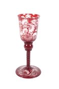 An Early 19th century Bohemian ruby cased engraved glass goblet decorated with hunting scenes