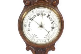 A circa 1900 carved oak two glass wall Aneroid Barometer with porcelain dial backs ,