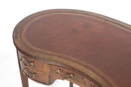 An Edwardian Kidney Shaped ladies Writing Desk the mahogany with satinwood cross banding and