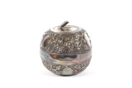 A Chinese white metal lidded box/ tea caddy of apple form profusely embossed with Tree peonies and