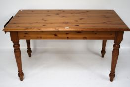 A pine kitchen table. With a drawer at o