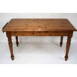 A pine kitchen table. With a drawer at o