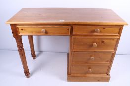 A contemporary pine desk and chair. The