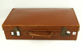 A vintage brown leather suitcase. With c