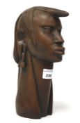 A West African carved hardwood head. H25