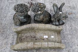 Four composite stone garden figures. Com