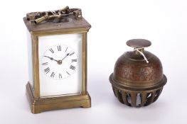 A French carriage clock and a brass bell.