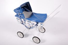 A 1970s child's pram. With a white metal