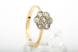 An early 20th century diamond seven stone 'daisy' cluster ring.