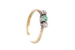An early-mid 20th century gold, emerald and diamond three stone ring.