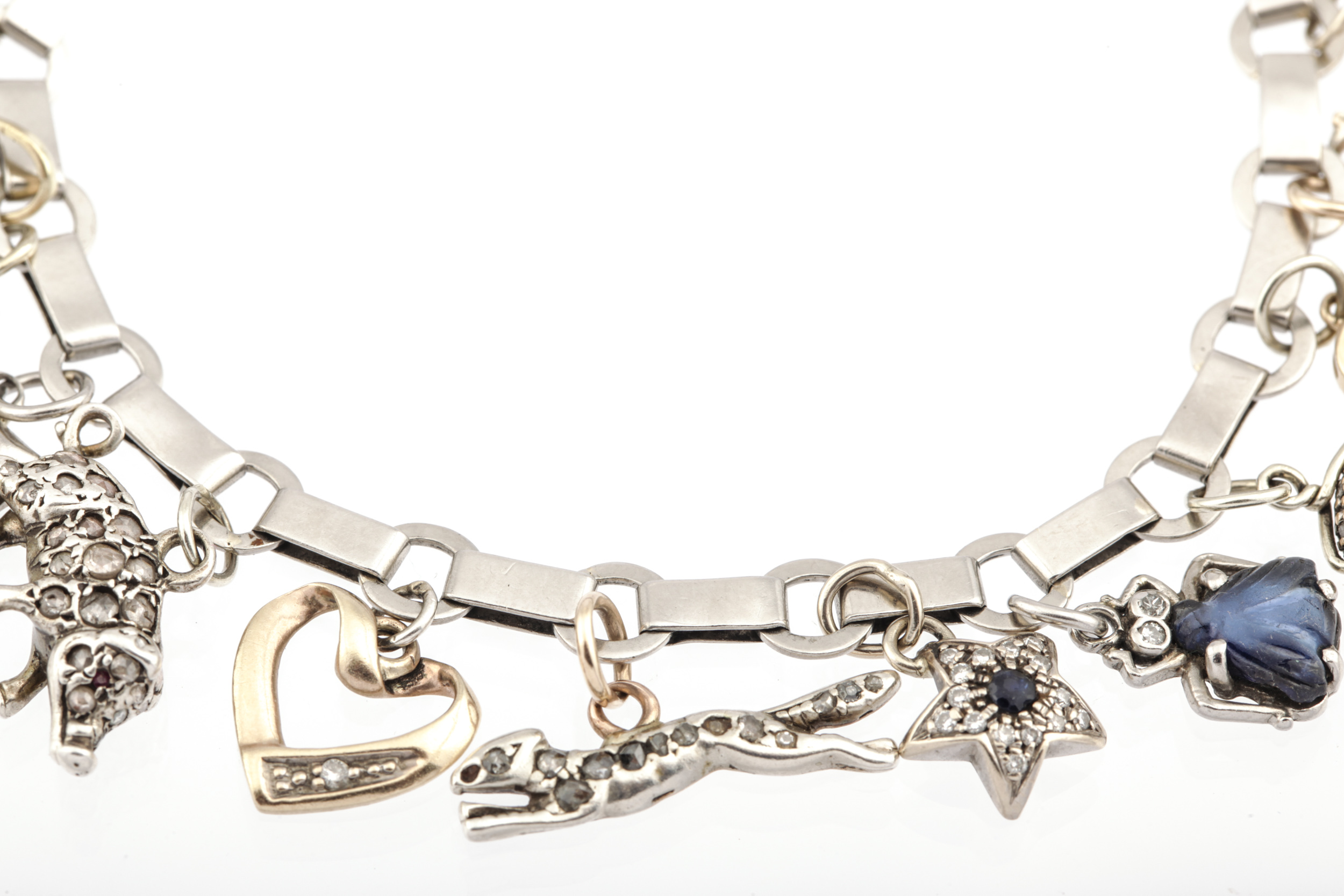 A 1940s French platinum bracelet in the manner of Boucheron hung with 21 various charms. - Image 4 of 6