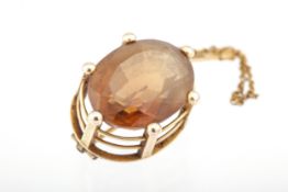 A mid-20th century gold and large oval citrine brooch. The stone measures approx.