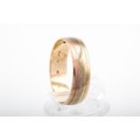 A vintage 9ct tri-colour gold broad wedding band, hallmarks for London 1984, 5.