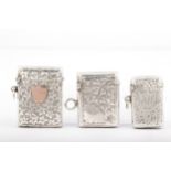 Three Edwardian silver vesta or match cases all engraved with foliate scrolls.