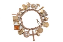 An early 20th century gold curb link 'charm' bracelet.